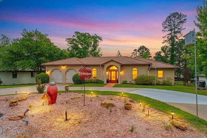 This distinctive adobe-style custom home blends timeless Southwestern architecture with warm, inviting interiors. Featuring a3-bedroom, 2-bath split floor plan, the home showcases signature design elements both inside and out—from its earthy tones and textured finishes to its seamless connection with outdoor living spaces. A circular drive welcomes you to the home’s striking exterior, highlighted by a durable Southern style tiled roof and thoughtfully designed outdoor areas. The screened porch, expansive tiled patio, and open deck create the perfect setting for entertaining or relaxing, all while embracing natural light and the surrounding landscape. Inside, the home’s character truly shines. Rich textures, architectural details, and quality finishes create a unique atmosphere that feels both grounded and refined. The open-concept living area flows effortlessly into the kitchen, where granite countertops, a large center island, double ovens, and abundant cabinetry with pull-outs provide both beauty and functionality. A spacious pantry and convenient wet bar add to the home’s thoughtful design. The breakfast nook opens directly to the screened patio, enhancing the indoor-outdoor lifestyle. An added extra feature that is a must have in Texas, this home is equipped with a generator home backup system for those unpredictable Texas storms. The formal living and dining spaces offer a warm yet elegant setting, while the private primary suite serves as a peaceful retreat with a Jacuzzi tub, oversized shower, dual vanities, and a large walk-in closet. Generously sized guest bedrooms provide comfort and flexibility for family or visitors. Set within a serene community with appealing amenities, this one-of-a-kind adobe-style home offers a perfect blend of architectural charm, modern convenience, and relaxed living.
