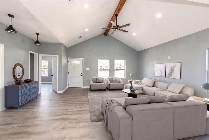 USDA-Eligible—Move-In Ready! Welcome home to this beautifully finished home featuring a spacious open-concept layout designed for everyday living and easy entertaining. Step into a light-filled living room with a vaulted ceiling, tasteful woodwork details, and a convenient built-in desk, perfect for working from home or managing household tasks. The kitchen is a standout with custom cabinetry, a large island with seating or extra storage, and brand-new stainless steel appliances ready for your favorite recipes. Both bathrooms continue the upscale feel with matching custom cabinetry and quality finishes. Unwind in the primary suite offering a tiled shower and a large walk-in closet. The two additional bedrooms are generously sized with ample closet space. Need storage? The oversized attic is ideal for seasonal items and features spray foam insulation for added efficiency. Enjoy the outdoors from two covered porches, and appreciate the practicality of a full utility room located just off the side entrance.