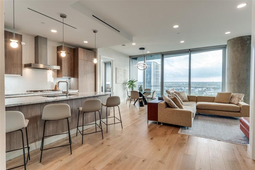 Welcome to an extraordinary opportunity to reside at Blue Ciel, one of Dallas' most prestigious addresses. This well-equipped 2 bedroom, 2.1 bath residence offers breathtaking southwest-facing city views through it's expansive, floor-to-ceiling windows. Bathed in natural light, the open-concept design flows seamlessly from the sophisticated living area to a chef’s kitchen featuring Miele appliances, sleek custom cabinetry, and a designer pendant lighting. The primary suite, complete with a lavish spa-inspired ensuite boasting a freestanding soaking tub, frameless glass shower, and a floating double vanity. Enjoy commanding 180-degree skyline views from your private balcony with an elegant fireplace. Additional features include California Closets in both rooms, a two-car garage, a climate-controlled storage unit, direct access to the Katy Trail, and exclusive world-class amenities curated for the most discerning tastes.