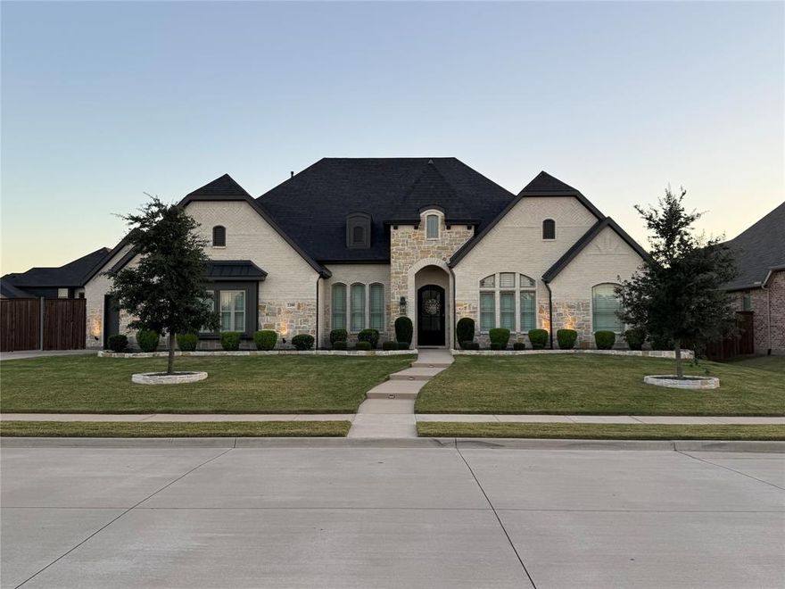 Ideally situated in the sought-after Falls of Prosper, this exquisite one-story 4-bed, 3-bath, custom-built home showcases an exceptional fusion of contemporary sophistication and enduring comfort - within Prosper ISD and zoned for Prosper High School. Set on an expansive lot of over one-third of an acre, this property offers limitless potential, elegant outdoor entertainment and shimmering pool offering peaceful relaxation. Open-concept layout with abundant natural light and engineered wood flooring throughout. Gourmet kitchen with quartz counters, stainless appliances and large island. Primary suite includes dual vanities, soaking tub, separate shower and walk-in closet. Two secondary bedrooms plus a 4th bedroom that can also serve as a study, flex or activity room. Spacious backyard features a sparkling pool and fully glass-enclosed patio, enhanced with a remote-controlled adjustable screen ideal for everyday lounging and hosting. In-ceiling speakers are installed throughout the living area, kitchen, and enclosed patio, providing seamless whole-home sound and an elevated entertainment experience.  Additional highlights include epoxy-coated flooring in both garages for low-maintenance durability and a clean, polished finish, along with an electric car charger for added convenience. This home is equipped with a whole-house generator and a high-end smart camera surveillance system, offering peace of mind and uninterrupted comfort year-round. Close to shopping, dining and main travel routes. Move-in ready and a must-see!