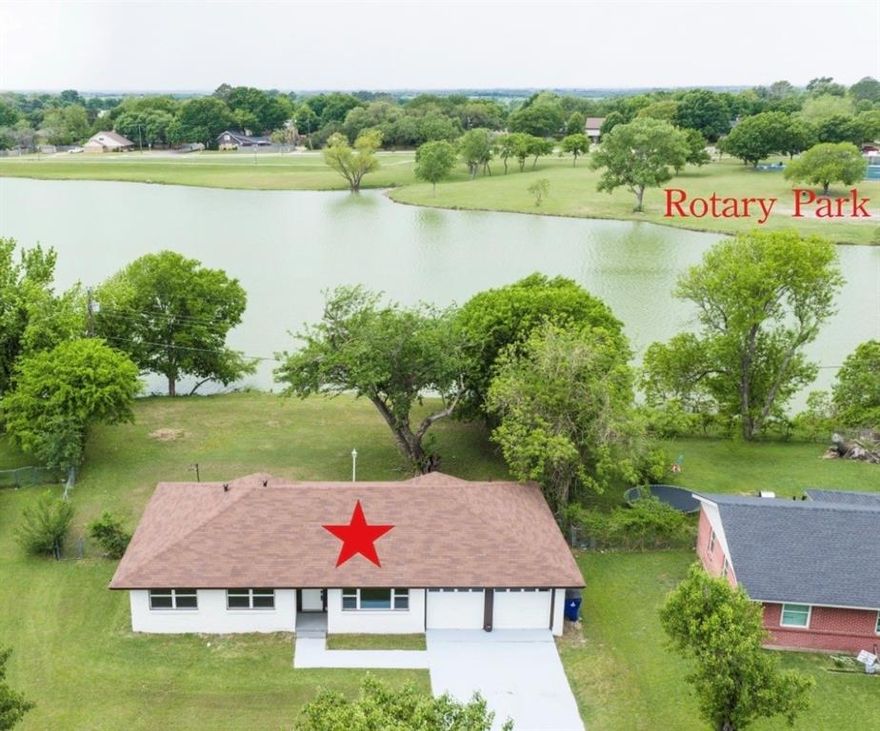 A rare opportunity to own a Lake home where your backyard becomes your getaway ideal for building a pier and enjoying fishing, paddleboarding, or simply unwinding by the water. Completely Remodeled Lakeside Retreat on Old City Lake! This beautifully updated 3 bedroom, 2 bath and 2 car garage home offers stunning water views and a bright, open-concept layout in a well-established Ennis neighborhood. Featuring luxury vinyl plank flooring throughout, fresh interior and exterior paint, new windows, a new HVAC system, and fully renovated kitchen and bathrooms, this home is truly move-in ready. Enjoy cooking in the gourmet kitchen overlooking the lake, complete with white cabinetry, granite countertops, stainless steel appliances, and a classic subway tile backsplash. The modern, expansive living area seamlessly connects to the kitchen and formal dining room, all with panoramic lake views. The spacious primary suite, located at the rear of the home for added privacy offers tranquil water views, a large walk-in closet, granite vanity, and a custom walk-in shower. Step outside to a large backyard with direct access to a private peninsula perfect for fishing, entertaining, or simply relaxing by the water. Located just minutes from the Goodwin Walking Trail and the 35.5-acre Rotary Park featuring a splash pad, event pavilions, a new playground, beach volleyball courts, and an outdoor National Fitness Court. This home is also conveniently close to downtown Ennis, where you’ll find shopping, dining, and year-round community events. Just 35 miles south of Dallas with easy access to I-45, it offers the perfect blend of small town charm and big city convenience. This thoughtfully remodeled lakeside home combines modern comfort with natural beauty. Waterfront setting with scenic views and room to create your own lakeside retreat perfect for boating and fishing activities. Schedule your showing today!