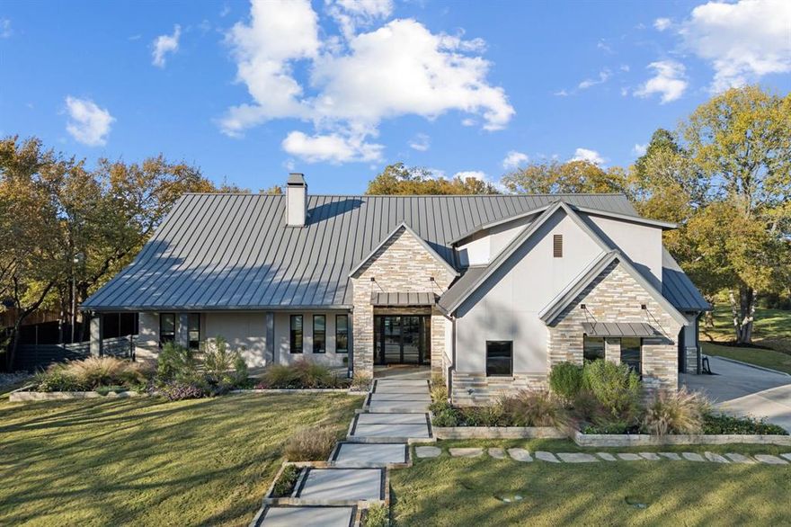 Set on more than three private acres with mature trees throughout, this Southlake estate offers a rare opportunity to own a meaningful piece of local history. The property carries ties to the original Johnson family farmhouse, with the original storage barn still standing as a reminder of its past. Expansive acreage and carefully considered architecture create a residence that balances refinement with livability. Natural light and curated finishes define the interiors, where each space connects seamlessly. A well-appointed kitchen anchors the main living areas, featuring floor-to-ceiling cabinetry,  two substantial islands with striking natural stone, integrated wine refrigeration, and Miele appliances including dual dishwashers. The kitchen opens to the family room and dining room in a cohesive open-concept layout. A wall of sliding glass doors extends the living space to the covered patio for seamless indoor-outdoor living. The floor plan includes a private study overlooking the front grounds, a separate bedroom with adjoining den positioned away from the primary suite and two secondary ensuite bedrooms, well suited for multigenerational living or guests. Upstairs, a media room with full bath allows the home to function primarily as a single-story residence while offering additional recreation space. The primary suite opens directly to the backyard with a stunning view. The covered patio with motorized screens, fireplace, outdoor kitchen, and pool table serves as year-round living space. Beyond, the pool is framed by an ipe wood deck and fire pit, offering a private backdrop of green space and mature trees. The third garage bay is configured as a heated and cooled gym and golf simulator, while the two-car garage features custom cabinetry, shelving, and epoxy floors. A spacious utility room and mud room enhance everyday functionality. Defined by privacy, scale, and heritage, this estate offers a rare combination of land and understated refinement.