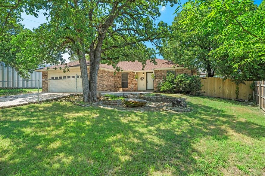 Don’t miss this wonderful opportunity to own a home in the heart of Azle! Nestled on a beautifully treed, nearly one-third acre lot, this property offers two fenced areas—ideal for children, pets, or enjoying both front and backyard spaces. This charming ranch-style home features classic brick exterior, a spacious living room filled with natural light, and vinyl flooring throughout with no carpet. The eat-in kitchen showcases granite countertops, a subway tile backsplash, and abundant cabinet space. Down the hallway, you’ll find updated secondary bedrooms with newer flooring and a guest bathroom featuring granite countertops and a tile tub-shower combination. The spacious primary suite includes vinyl flooring, two closets, and a private ensuite bath with a walk-in shower. The expansive backyard provides plenty of room for grilling, entertaining, and outdoor enjoyment for both family and pets.