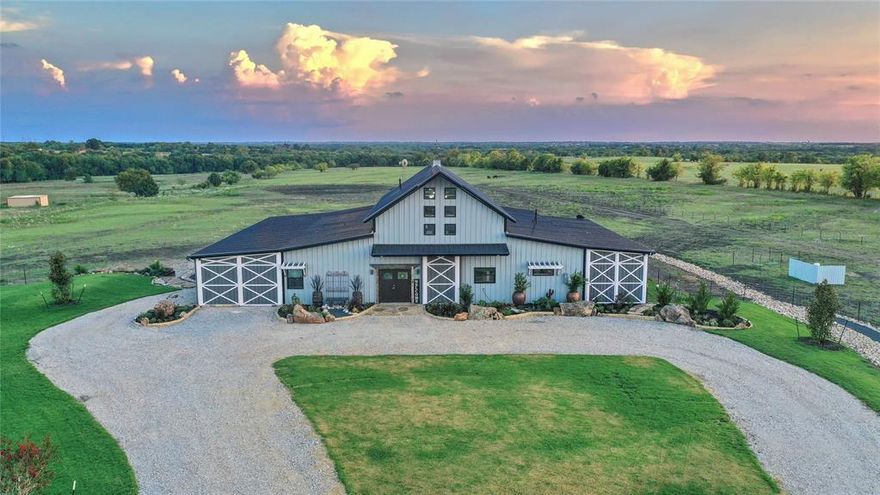 TEXAS ELEGANCE with this custom Luxury Bardominium on 53+ rolling ac of stunning views overlooking a 25AC stocked lake and pond. Bring your VISIONS & DREAMS as this property has plenty of room to build additional homes for a family compound, wedding venue, or Airbnb.  Looking for a great piece of land for development? with frontage on CR 134, the location is perfect for a boutique residential neighborhood! The open floor plan is ideal for entertaining large crowds with commercial grade kitchen appliances, custom Vent-a-Hood and two massive 10' granite islands,  Cuddle up to a good book in the great room anchored with a grand CO River Rock FP and 27' ceilings. The custom iron staircase leads to a magnificent gameroom, 4 queen bunkbeds, pool table, and ensuite bath.  Below ground is a 40' safe room that would be a fantastic wine grotto! This working ranch has 2 barns, RV storage, and corral. Celina is one of the fastest growing cities in TX! Ag exempt and minutes from Frisco and McKinney