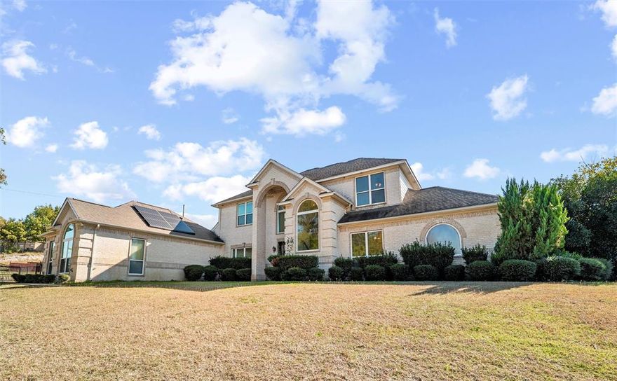 Welcome to your private retreat on just over an acre, featuring 5 bedrooms, 4 full baths, and nearly 3,500 sq. ft. of beautifully refreshed living space. Tucked within a peaceful neighborhood just off the beaten path, you’ll enjoy a sense of space and room to breathe, yet still be only 20 minutes from downtown Fort Worth—close enough for everyday convenience and commuting. The spacious living area flows seamlessly into the kitchen, dining, and breakfast rooms, all overlooking the backyard oasis and sparkling heated pool with spa and water feature. The main level includes a dedicated office, a generous primary suite with a sitting area, pool views, and direct patio access, plus an additional downstairs bedroom ideal for guests or multigenerational living. Upstairs you’ll find three more bedrooms, two full baths, and a versatile media-game room. Step outside to enjoy a covered patio, cabana, and a fully equipped guest house complete with built-ins, a full-size refrigerator, 2-burner cooktop, walk-in shower, dedicated water heater and HVAC. Perfect for long-term guests, in-laws, or a private studio. Freshly painted throughout the interior with new carpet in four bedrooms, this home is move-in ready and designed for comfort, entertainment, and year-round enjoyment.