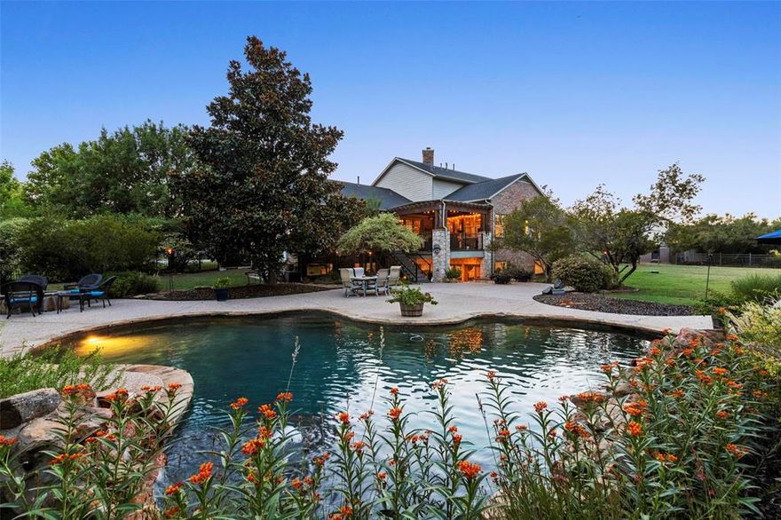 Exquisite Tim Jackson Custom Home on 1.4 Acres in Sought-After Frisco ISD! Tucked away on a quiet cul-de-sac, this stunning estate offers timeless elegance, privacy, and exceptional craftsmanship on a sprawling 1.4-acre lot. The grand front porch and lush, mature landscaping create impressive curb appeal, while the backyard is a true retreat featuring a sparkling pool with waterfall, three distinct patio areas, an extended deck with built-in fire pit, and abundant green space—perfect for pets or play. Inside, you'll find luxurious updates throughout, including hand-scraped hardwood floors, designer paint selections, and custom lighting. The spacious kitchen is a chef’s dream with a large granite island, stainless steel appliances, 5-burner gas cooktop, double ovens, and extensive cabinetry and counter space. A stone fireplace and striking accent wall add warmth and character to the living areas. This home offers 5 generously sized bedrooms, each with its own ensuite bath and walk-in closet, providing ultimate comfort and privacy. The walk-out basement is an entertainer’s haven—complete with a large bedroom and full bath, perfect for guests or a private in-law suite. Plus, an insulated 21x40 storage area presents endless possibilities for a home gym, studio, holiday storage or a future finished space. Additional highlights include an updated 11x17 utility room, a 3-car garage with extended parking pad, and a sprinkler and fire suppression system for peace of mind. Zoned to top-rated Frisco ISD and conveniently located near premier shopping, dining, and major highways—this property offers the best of luxury living with the convenience of city amenities.