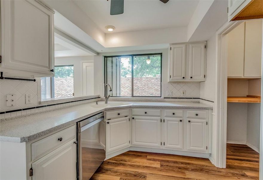 Impeccably maintained three-bedroom, two-bathroom corner unit residence in Addison! This home boasts an open and airy floor plan with luxurious vinyl plank flooring gracing the expansive living area and kitchen. The high ceilings and abundant natural light add to the inviting ambiance. The well-appointed kitchen features a breakfast bar, dining area, and a sliding window leading to the patio, seamlessly blending indoor and outdoor living.

One bedroom is conveniently located on the main floor, while the primary and an additional secondary bedroom are situated upstairs. The patio, transformed into a tranquil oasis with artificial turf, offers a perfect space for relaxation and entertainment. As an end unit, it provides added privacy, making it an ideal retreat. Residents can enjoy the community pool and clubhouse, along with easy access to walking trails, dining options, and entertainment venues.