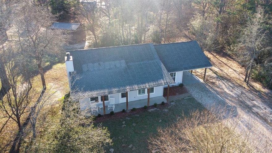 Beautifully maintained home located within the gated resort community of Holly Lake Ranch, offering true single-level living with no interior steps thanks to its slab foundation and low-maintenance Hardie board siding. This light and bright open-concept layout features a spacious living area with a cozy wood-burning fireplace, an inviting eat-in kitchen with a built-in hutch, and a versatile flex space ideal for a dining room, sunroom, or home office. The thoughtfully designed split-bedroom floor plan provides added privacy, with both bedrooms overlooking the backyard, while the primary suite includes a walk-in shower. An attached one-car covered carport offers additional storage and direct access into the sunroom for everyday convenience. Recent updates include interior and exterior paint completed in 2023, a roof replacement in 2023, an HVAC system approximately two years old, and septic lines replaced within the last few years, making this home truly move-in ready. Residents of Holly Lake Ranch enjoy a gated, amenity-rich lifestyle with 24-7 on-site security, multiple lakes for fishing and water activities, an 18-hole golf course, fitness center, tennis and pickleball courts, scenic walking trails, and a wide array of recreational offerings that create a year-round resort-style experience.