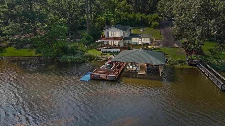 Wonderful rustic waterfront home on lake Lydia nestled along the Texas Dogwood Trail. This secluded, private lake offers serene rolling hills, abundant wildlife, and excellent fishing. Built in 1947, the solid two-story home features 125' of waterfront, original tongue-and-groove walls, upstairs wood plank floors, a large primary suite, two decks, and a spacious eat-in kitchen—ready for your personal touch. Huge covered dock with two boat stalls, lift, storage, and sitting areas. Close to shopping, dining, and with easy access from DFW. Lake Lydia is perfect for boating, fishing and making lifelong memories. New roof and main water line.