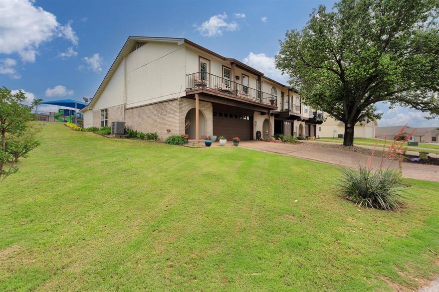 Welcome to resort-style living in the prestigious gated community of DeCordova Bend Estates! This beautifully updated 2BD, 2.5BA townhome delivers 1,530 sq ft of effortless comfort. The large inviting living room sets the tone with a stone fireplace, archways, rich wood laminate floors, and an abundance of natural light — the perfect space to relax or entertain. The renovated kitchen is a showpiece with painted cabinetry, newer hardware, gleaming granite countertops, stainless appliances, classic subway tile backsplash and a charming window above the sink. Both bedrooms are generously sized, with the primary suite offering the luxury of two closets. Refreshed bathrooms throughout, plus a convenient guest half bath that keeps your private spaces just that — private. Step through the sliding glass door onto the large covered back patio — your personal retreat for relaxing in the shade on warm summer days. The landscaped flowerbeds and low-maintenance yard add curb appeal without a lot of upkeep. A fenced backyard with a gate that opens directly to the community playground, pool, and clubhouse — it's like having a resort in your backyard. Head upstairs and step onto the front balcony for a breathtaking peek at the lake on crisp winter days. And for the golf enthusiast, the oversized 2-car garage plus large golf cart garage with extra storage has you covered — with the marina and golf course just moments away. DeCordova Bend Estates offers a truly unmatched lifestyle: 24-hour gated security, pickleball, volleyball, tennis, basketball, and so much more. This is lock-and-leave living at its finest — just move in and enjoy everything this incredible community has to offer!