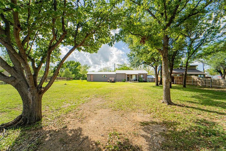 Hubbard Creek Lake, lakeview cabin situated on two well-groomed lots, offering 921 sq ft with 2 bedrooms and 1 bathroom. Open kitchen flows into the living area, creating a comfortable and functional layout. Spacious laundry room provides extra storage space for lake gear and fishing equipment. Home features a durable metal roof and carport for covered parking. A 400 sq ft Derksen-built storage building with roll-up door and side entry is attached and offers excellent potential to be converted into additional living space. Conveniently located just a quarter mile from the public boat ramp, making lake access quick and easy. Ideal for a weekend getaway or full-time lake retreat—come enjoy lake living and make lasting memories.