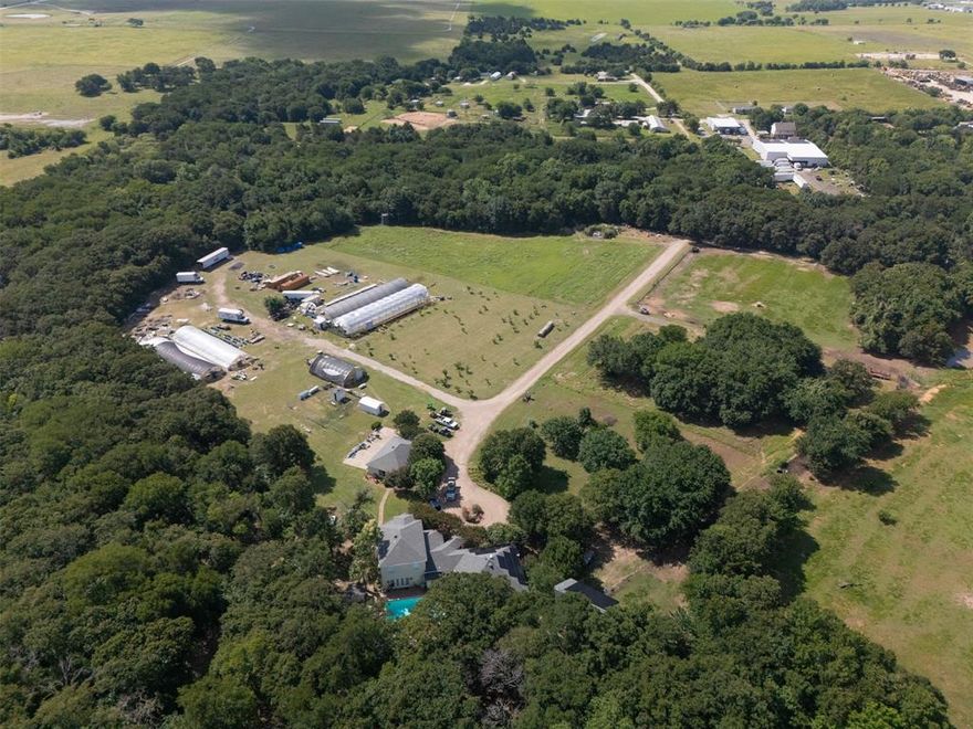 Includes 6521 Asher Road.

Turnkey North Texas Agribusiness Estate with pool, wine cellar, orchards, and commercial facilities on 40.38 acres in the growing Dallas–Fort Worth corridor, located in desirable Alvarado, Johnson County.

This unique property combines agricultural production with commercial infrastructure, ideal for freight and distribution, food processing, cold and freezer storage, agribusiness operations, or a private estate with income potential.

Features approximately 12,000 sq ft of hydroponic greenhouses with grow lights, climate control, and irrigation, plus over 15,000 sq ft of insulated metal buildings, a 2,000 sq ft walk-in cooler, 1,000 sq ft freezer, warehouse space, and showroom-manufacturing area with dock-height loading—perfect for production and distribution.

Equipped with 3-phase electric, solar infrastructure, and a fully operational irrigation system supporting mature peach orchards and crops. The cross-fenced acreage includes a pole barn and offers expansion potential for a larger agribusiness or logistics campus.

The main residence offers approx. 3,362 sq ft with 4 bedrooms, 3.5 baths, chef’s kitchen with dual islands and Miele appliances, wine cellar, and resort-style outdoor living with pool, spa, outdoor kitchen, brick-oven patio, and pool house.

Additional improvements include a detached 3-car garage and 1,200 sq ft guest house with full kitchen and private living quarters. Built in 1992, this gated property offers co-op water, septic, and easy access via asphalt and gravel roads.

6521 Asher includes a separate ~1,600 sq ft home (3 bed, 2 bath) currently used as office space.

Located near the Fort Worth expansion corridor with access to major highways. Infrastructure improvements, including a planned crossover bridge near Asher Road, are expected to enhance accessibility.

Rare opportunity with strong commercial, agricultural, and lifestyle appeal.