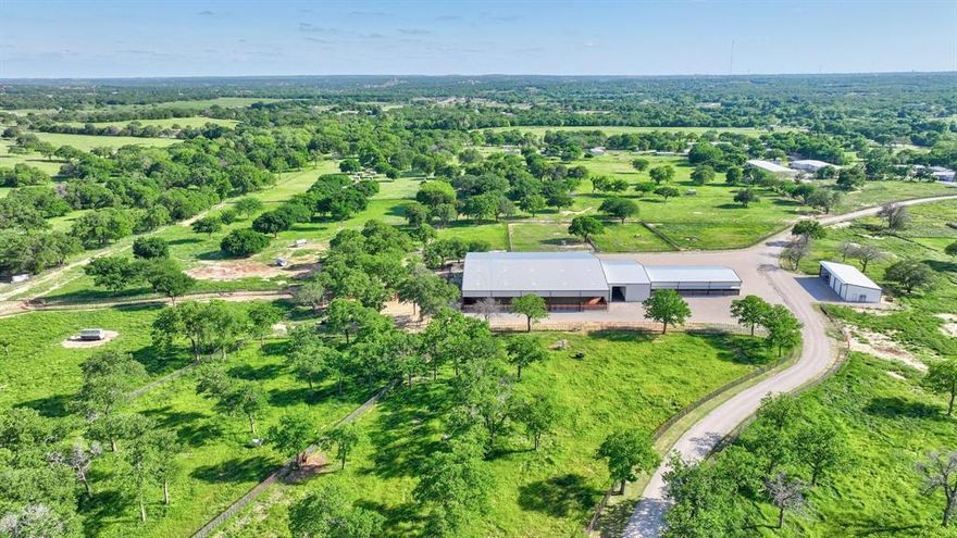 Nestled in the heart of Parker County, this elite equestrian estate is a horse enthusiasts dream. Featuring a 125x125 covered arena with room to expand and holding pens at each corner and alleyway. Attached show barn with twelve 14x14 stalls with large airplane hangar doors on the top half that open to allow sun, air through the barn for the horses. UFO LED lights, 42x84 alley tie area, wash rack, temp controlled custom tack room with rotating tack doors for added convenience, an oversized restroom, and no seam rolled rubber flooring throughout. Two 5,000-gallon storage tanks, two 5.5hp industrial vertical Goulds pressure pumps, with a 3HP in-ground well pump. Not one but two energy efficient ICF concrete custom homes both with 3 Bd, 2.5 Ba, and office. Water filtration system, tankless water heater, custom white oak cabinets and floating shelves, seamless quartz countertops, Chef's gas stove, high ceilings, wood beams, 10ft doors, white oak wood floors and high end carpet with extra pad, and EV chargers in garage. Your dream ranch awaits.