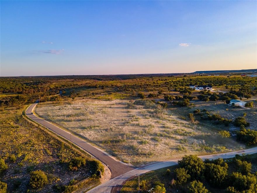 BARNDOMINIUM LOT! Located in the ranch section of Sportsman's World, this is one of VERY FEW areas at Possum Kingdom Lake you can build a barndo style home in a planned development. Subject to Sportsman's World Ranch Owners Association rules. Almost 5 and half acre tract, huge even level building site. At the end of Jowell creek as it comes out of Hells Gate Cove. Sportsman's World inhibits a true rustic setting in North Texas Hill Country and features incredible cliff line estates, Lakehomes, and Ranchettes like this one. Common amenities include: pool, pavilion, tennis court, stables, & playground. Also nearby is the award winning VIP Bluff Creek Marina that gives owners the option of leasing a boat slip & full marine service, and the PK General Store for a quick burger & hosts live music. This is THE piece of land you've been waiting for at PK LAKE if you want to build a minimalist barndo home!