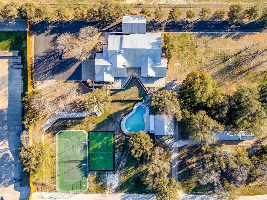 Own a piece of Texas history! This 20-acre estate has it all from entertainment to self-sufficiency - fully updated & move-in ready! Enjoy the Outdoors with a 10' deep pool, 2-story guest pool house, volleyball & basketball & tennis courts, 2 fenced pastures, fly-equipped milking barn with stalls, & a pond. Other features include private water system, peach, pecan & pear trees, 15-zone sprinkler, concealed safe room, bulletproof windows, 25 SEER HVAC WiFi controlled ac units, remote blinds, 4-car garage, & an upstairs man cave with private balcony. Outside city limits, no livestock or building restrictions, 5 min from Downtown Weatherford, 20 min from Fort Worth.