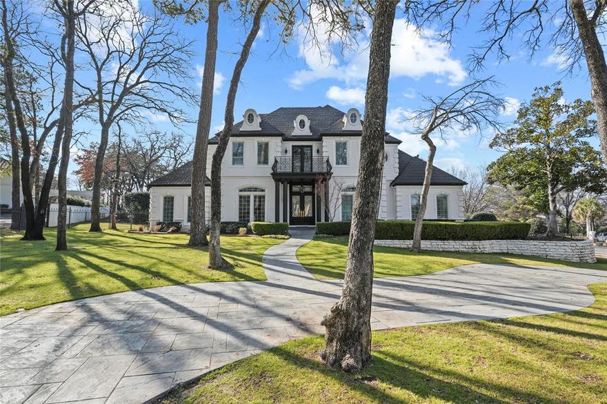 Experience refined living in this beautifully reimagined custom estate, nestled on a private, treed one-acre lot in Laurelwood Park—one of Southlake’s most coveted neighborhoods. Ideally located with quick highway access, enjoy a short drive to DFW Airport, premier shopping, and top dining destinations.
Thoughtfully renovated to blend modern sophistication with timeless architectural charm, this home showcases elegant crown moldings, coffered ceilings, and striking design details throughout. A grand sweeping staircase anchors the impressive foyer, flanked by a private executive office with custom built-ins and a hidden passage leading discreetly to the primary suite.
The light-filled primary retreat offers serene backyard views, a cozy sitting area, and a spa-inspired ensuite—an ideal space to unwind and recharge. The updated chef’s kitchen is a true showpiece, featuring Viking and Sub-Zero appliances, generous prep space, and seamless flow into the main living areas, perfect for everyday living and entertaining alike.
All bedrooms feature ensuite baths, providing comfort and privacy for family and guests. A rare third-floor mother-in-law suite adds exceptional flexibility for multigenerational living or extended stays.
Step outside to your own resort-style backyard complete with a large pool and spa, outdoor kitchen, custom fire pit, and private basketball court—surrounded by mature trees that create a peaceful, park-like setting.
This is a rare opportunity to own a fully updated estate that offers space, privacy, and timeless appeal in the heart of Southlake.