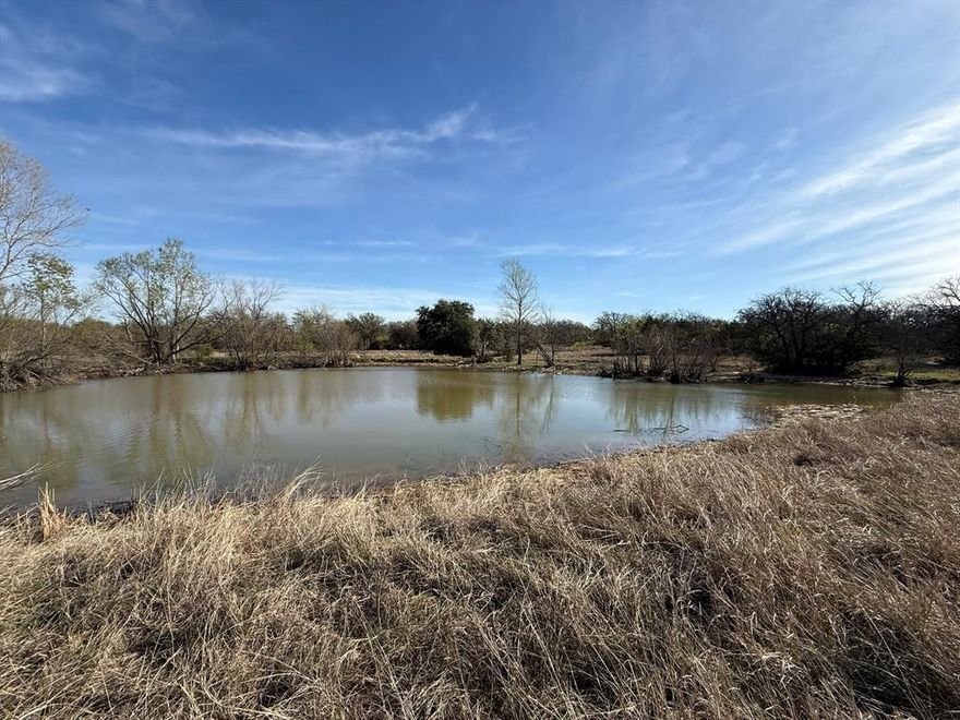 Rare opportunity to own a truly exceptional tract in Hood County offering a unique combination of natural beauty, usability, and long-term upside. This heavily wooded property features gently rolling terrain that creates a private, scenic setting ideal for a custom estate, ranch, or future residential development.

Three large tanks enhance both the functionality and appeal of the land, providing water features that attract wildlife and add to the overall character of the property. The mature trees throughout offer natural privacy, shade, and a picturesque backdrop for any future build.

A substantial metal barn is already in place and presents an outstanding opportunity to convert into a barndominium or finished living space, allowing for immediate use while planning your long-term vision. Whether used as a workshop, storage, or future residence, the structure adds significant value and flexibility.

The property benefits from both north and south (two) gated access points to major roads, providing excellent accessibility and multiple options for entry, layout, or potential division. This feature further enhances its appeal for those considering development or multiple homesites.

Currently ag exempt, the property offers valuable tax advantages while maintaining flexibility for a variety of uses. Whether you’re looking to build a private retreat, establish a ranch, create a family compound, or invest in one of the fastest-growing areas in North Texas, this property delivers.

Land with this combination of trees, water, topography, access, and development potential is increasingly hard to find. Come walk the property and experience the possibilities firsthand.