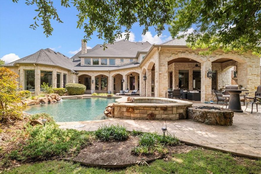 Welcome to this Luxurious Lonnie Gray custom built home in the heart of Frisco. Appraisal in hand at $2.5 million, offers significant equity. Upon entering, you'll find an open layout bathed in natural light. The hardwood hand-scraped floors and extensive molding create an ambiance of sophistication & elegance. Each generously sized room is adorned with large windows, enhancing the bright & airy feel. The home features multiple rooms, providing ample space for relaxation and entertainment. The downstairs media room, fully furnished with media furniture and a screen, is a standout. The property includes 5 spacious bedrooms and 7 baths, with the primary bedroom conveniently located downstairs. The large kitchen is a chef’s dream, featuring an island, granite countertops, and a built-in refrigerator. The breathtaking backyard oasis includes a pool with a waterfall and spa, an outdoor kitchen, and a covered patio with a fire pit, perfect for entertaining or relaxing. Don't miss this one