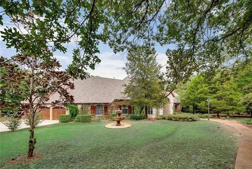 Welcome home to your very own European Tudor style estate, where classic charm meets modern comfort in the highly prestigious Oak Shores lakeside community.Situated on nearly 2 acres, this custom-built residence offers the ideal blend of luxury, functionality & tranquility—all just moments from city conveniences.You will be captivated by the graceful architecture, mature landscaping & park-like setting that surrounds this one-of-a-kind property. The backyard feels like your own private state park—an enchanting retreat framed by majestic trees & lush greenery that create a peaceful, secluded haven you’ll never want to leave. Boasting 5 bed, 3 bath & a 3-car garage, this thoughtfully designed floor plan is filled with elegant details & quality finishes throughout. Solid 8-foot solid wooden doors, hardwood floors, plantation shutters &cedar wood beams in the liv rm  exude warmth and character at every turn.The gazebo-style ceiling in the breakfast rm  the& abundance of natural light add a welcoming touch of charm and refinement. The gourmet kitchen that will delight any culinary enthusiast. Outfitted with top-of-the-line Viking appliances, granite countertops,large island,2 oversized sinks,custom cabinetry & a built-in wine cooler,butler pantry, this space is perfect for both everyday living and entertaining guests.The primary suite is a true sanctuary, featuring a cozy fireplace, tranquil views of the pool & towering trees & a luxurious ensuite bath with a steam jacuzzi—the perfect retreat after a long day. Step outside to your private backyard oasis, where a custom 25K gallon heated saltwater pool with a stunning Oklahoma rock waterfall takes center stage.Additional electrical connections are located by the pool. A cement slab with water and electric connections offers endless possibilities. Additional features include triple insulation,water well,wrought iron fencing,entire house has an intercom system and stereo & much more!Don't miss out on this fabulous property!