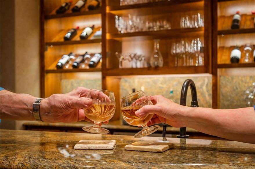 Rare Sharif Munir Frisco custom built home in the gated and guarded community of Stonebriar Park checks all the boxes for the sophisticated buyer. Quality finishes throughout makes this an excellent entertaining house. Have cocktails at your own bar before dining with the patio doors open listening to the waterfall in the pool and spa. The first level also includes the master suite with a private view of the back yard, a secondary bedroom with an en suite full shower bath, remodeled kitchen with a wolf gas stove and all the bells and whistles, family room with cast stone fireplace, executive office overlooking the pool, a garage entry with reception area, and a separate laundry room with a wet area for clothes or washing the dog. The winding floating staircase takes you to the second executive office overlooking the pool. Two full bedrooms with en suite private bathrooms are in the other wing. After the dinner guests have gone head to the oversized combo game-media room to unwind.