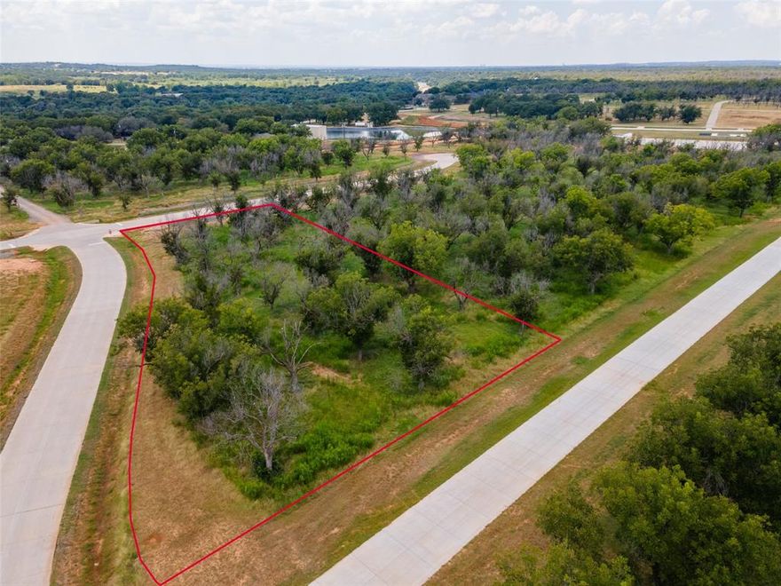 This 1.6 acre corner lot offers an exceptional opportunity to build your custom home and private hangar in one of Texas' most unique residential airpark community.  The lot has direct taxiway access and is centrally located with convenient access to the runway and fuel station.  This one of a kind community offers country club living with two golf courses, a marina, tennis, pickleball, swimming pools, equestrian center, activity center, restaurants, and more all surrounded by the natural beauty of mature pecan trees.  A rare opportunity for pilots to enjoy both aviation convenience and resort style living.