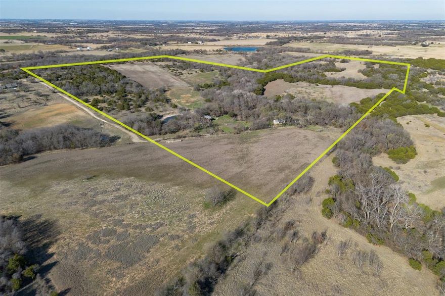 Fabulous 106.28-acre ranch located just outside Dublin, approximately 45 minutes west of Stephenville. This diverse property offers a beautiful mix of productive bottomland, rolling hills, and elevation changes that provide scenic views and multiple ideal building sites. The ranch is fenced and cross-fenced and is currently utilized for cattle grazing with established hay pastures and natural range mix. Several stock tanks, a water well, electricity, and a natural spring with a spring house add to the property’s functionality and charm. The land is Ag exempt and well-suited for continued agricultural use, recreational enjoyment, or long-term investment potential. A standout feature of the property is the old rock home known locally as the “Friendship House.” While it has not been lived in for years and will require TLC, the exterior stonework remains beautiful and full of character. With restoration, this home could once again reflect its original country charm and serve as a stunning ranch residence or weekend retreat. Mature oak trees, abundant wildlife, and excellent hunting opportunities make this property equally attractive for recreation. Located at the end of the road, the ranch offers privacy and seclusion while still being conveniently accessible. If you are needing an immediate residence, an additional 48 contiguous acres is also available (MLS #21189866) featuring a 1,752 sq. ft., 2 bedroom, 2 bath home with a pool. This adjoining tract is being sold separately but offers a seamless expansion opportunity. With vision and a little TLC, this property presents incredible building potential. Priced to sell, this 106.28-acre ranch will not last long.