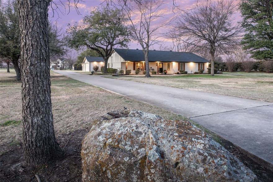 Located on 2.2 acres with no HOA, this 5-bedroom, 3-bathroom property in Lovejoy ISD offers a combination of acreage living, functional updates, and flexible-use spaces. Originally built in 1985 and remodeled in 2022, the home features an open layout designed to support both everyday living and gathering areas while maintaining separation between private and common spaces.  Interior improvements completed during the 2022 remodel include updated finishes and improved flow between the main living, kitchen, and dining areas. Windows were replaced approximately five years ago, and the roof and gutters were replaced in 2022. The gutter system includes integrated leaf guard protection designed to reduce maintenance. The floor plan includes five bedrooms and three full bathrooms. One secondary bedroom includes a closet with washer and dryer hookups, providing the option for a secondary laundry area, guest suite functionality, or flexible utility space. The property includes a detached workshop with electricity and interior space suitable for RV storage, boat storage, or equipment use. The workshop structure offers additional utility for hobby, storage, or workspace needs. Situated on approximately 2.2 acres, the property allows for a variety of outdoor uses consistent with local regulations. Animals are permitted. The location provides access to Lovejoy Independent School District while maintaining acreage spacing and privacy typical of rural-residential properties.