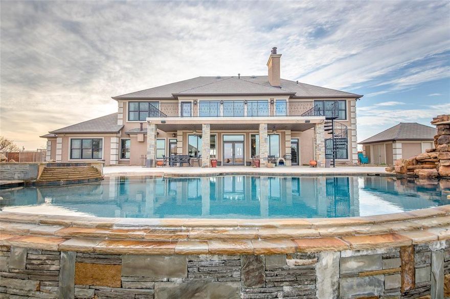 Just 15 minutes from Wichita Falls, retreat to this lavish oasis. Custom built for over $2.6m in 2011. Shooting range, sand volleyball, 6 stall barn, kennel, 5 stock tanks. Open floor plan, gourmet eat-in kitchen, two story family room, media room, game room, handicap accessible in-law suite, 2 utility rooms. Heated infinity pool with swim-up bar, hot tub, cabana with full bath, gourmet outdoor kitchen. 160 fenced acres total.