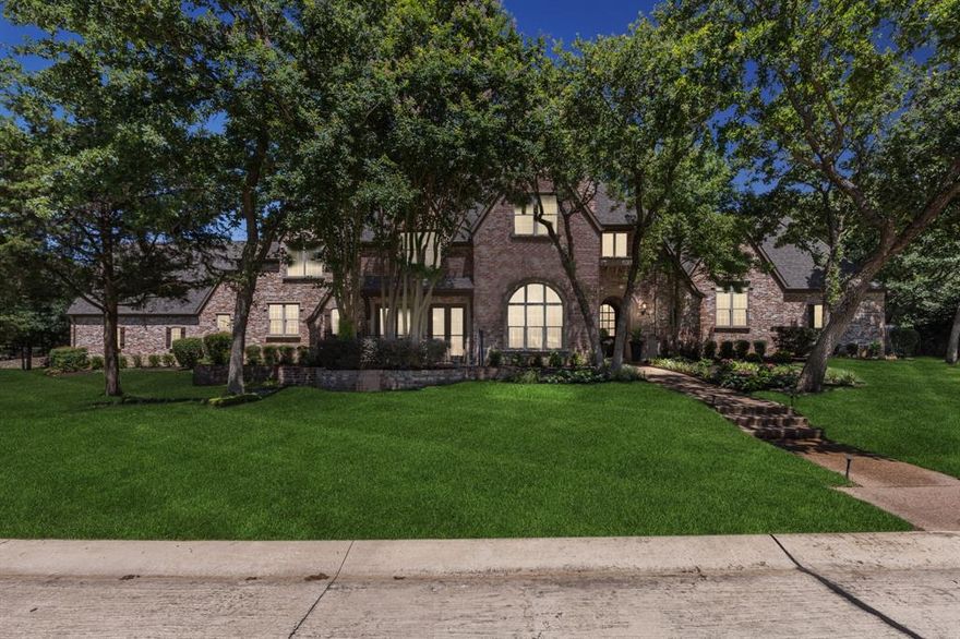 Experience unparalleled luxury & elegance in this exquisite 6-bedroom, 6.5 bath estate nestled in the heart of Southlake. Spanning over 6,200 square feet on a lush.688 acre lot, this property is designed for the discerning homebuyer seeking sophistication, tranquility & privacy.  The home boasts 5 living areas, providing ample space for both family activities & serene relaxation. Each bedroom is a private retreat with en-suite bathrooms adorned with designer touches, ensuring comfort and privacy for all. The home office, located at the front of the house, features elegant wainscoting and a vaulted ceiling, creating a perfect workspace enhanced by a convenient half bath nearby. The formal living areas are flooded with natural light, creating a warm & inviting atmosphere throughout.  Surrounded by mature trees, this home offers a peaceful & picturesque setting that makes coming home a delightful experience. Don't miss the opportunity to discover this one-of-a-kind property for yourself.