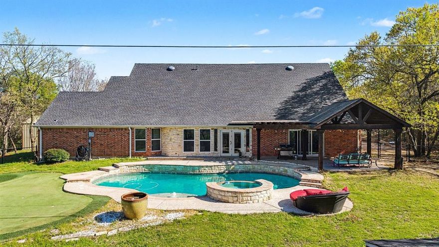Highly motivated sellers as they are relocating out of state!! Tucked away on 2 private acres in desirable Waxahachie, this stunning 4-bedroom, 3-bath home offers the perfect blend of space, comfort, and privacy. Situated on a beautifully positioned piece of land, this property provides peaceful country living while still being just minutes from everything Waxahachie has to offer.
Step inside to an amazing chef’s kitchen designed for both entertaining and everyday living, featuring an oversized island, commercial-grade refrigerator, bar seating, and a built-in desk area, creating the perfect gathering space for family and friends. The home also features an oversized dining room, ideal for hosting holidays and special occasions, along with a butler’s pantry that provides additional prep and storage space.
A dedicated office at the front of the home makes working from home easy, while the flexible layout also includes a game room and a bright sunroom overlooking the backyard.
The oversized primary suite is a true retreat with a completely updated spa-like bathroom featuring a soaking tub, walk-in shower, and dual vanities. Two secondary bedrooms share a charming Jack-and-Jill bathroom, offering both style and functionality.
Step outside and enjoy your private backyard oasis complete with a gorgeous in-ground pool, covered back porch, sunroom, and your very own putting green—perfect for relaxing or entertaining. A metal storage building has also been added,  the metal shop building is 1200 sqft providing additional storage and functional space for hobbies, equipment, or outdoor gear.
This home is full of valuable upgrades, including pool equipment, updated windows, roof, and HVAC, giving buyers peace of mind and added value.
With incredible indoor living areas, resort-style outdoor amenities, and unmatched privacy on 2 acres, this Waxahachie property truly has it all.