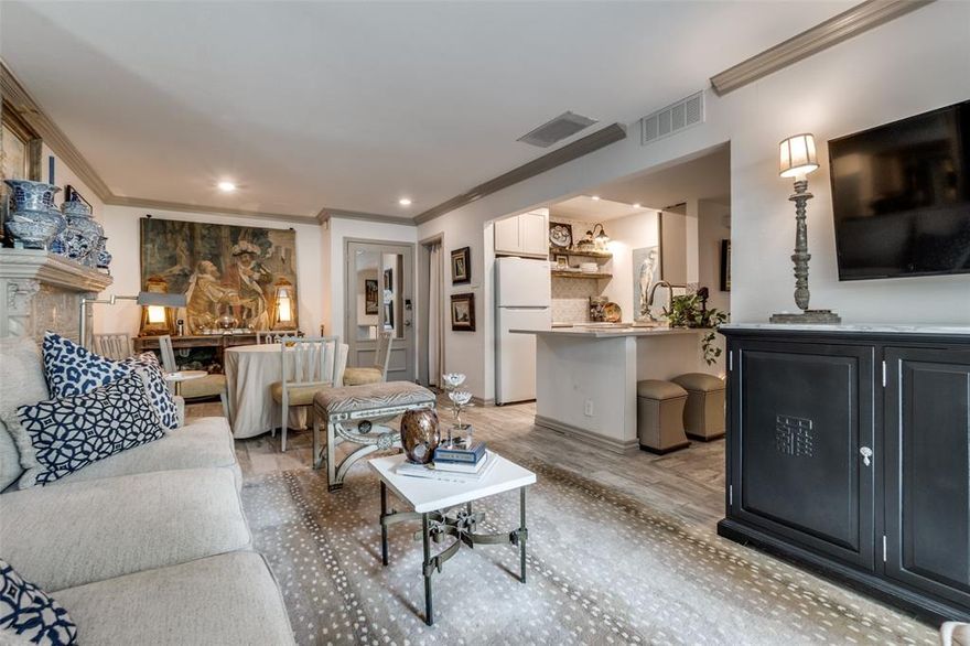 We are thrilled to be able to offer another premium first-floor end unit with a wrap-around deck overlooking the creek! The beautiful, updated kitchen features replaced cabinetry, quartz countertops & oversized under-mounted sink. The stunning tile backplash with open wood shelves & sconces above the range provides the latest in design trends. Other wonderful features include natural oak-look flooring throughout, an ornate decorative fireplace in the living room, plantation shutters, crown moldings & eye-catching light fixtures including the star-burst fixture in the primary bedroom!  Enjoy the tranquil sounds of Turtle Creek from your expansive deck, while playing with your dog or lounging at the exceptionally large on-site pool! Located just blocks from Cedar Springs entertainment mecca, 5 minutes to Love Field Airport & quick access to downtown. River Oaks features secured-access gates, towering oak trees, common garage parking & a club house.