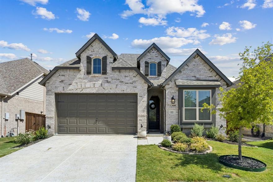 Experience style, comfort, and functionality in this beautifully designed single-story Highland Home, featuring the sought-after Escalade floor plan with 4 bedrooms, 3 full baths, a dedicated media room, and a private study. Light-colored luxury vinyl plank flooring flows throughout the main living areas, complementing the elegant 5-panel interior doors and refined finishes found throughout the home. This thoughtfully designed split-bedroom layout offers privacy and flexibility, with two secondary bedrooms tucked off one side of the entry hall and a third located on the opposite side, each connected by arched hallways that create a sense of architectural charm. At the heart of the home, the kitchen impresses with warm wood cabinetry, sleek quartz countertops, a walk-in pantry, stainless steel appliances, and a gas cooktop. The oversized island—painted a chic accent blue—offers ample seating with a breakfast bar and is highlighted by stylish pendant lighting. The kitchen flows seamlessly into the spacious dining area and open living room, where a gas fireplace with tile surround and wood mantle creates a cozy focal point. Built-in cabinetry with quartz counters adds storage and style. The private primary suite is a true retreat, featuring a luxurious en suite bath with a soaking tub, separate tiled shower, dual vanities, and a generous walk-in closet. Additional features include a separate utility room, media room for movie nights, and a covered patio with ceiling fan for comfortable outdoor living. Located in the master-planned community of Sandbrock Ranch, residents enjoy access to over 6 miles of walking trails, two stocked fishing lakes, the Carriage House amenities center with resort-style pool, fitness center, play structures, recreation fields, event lawn, and the whimsical Lookout Treehouse. This home offers the perfect blend of modern living and community charm—don't miss your opportunity to make it yours.