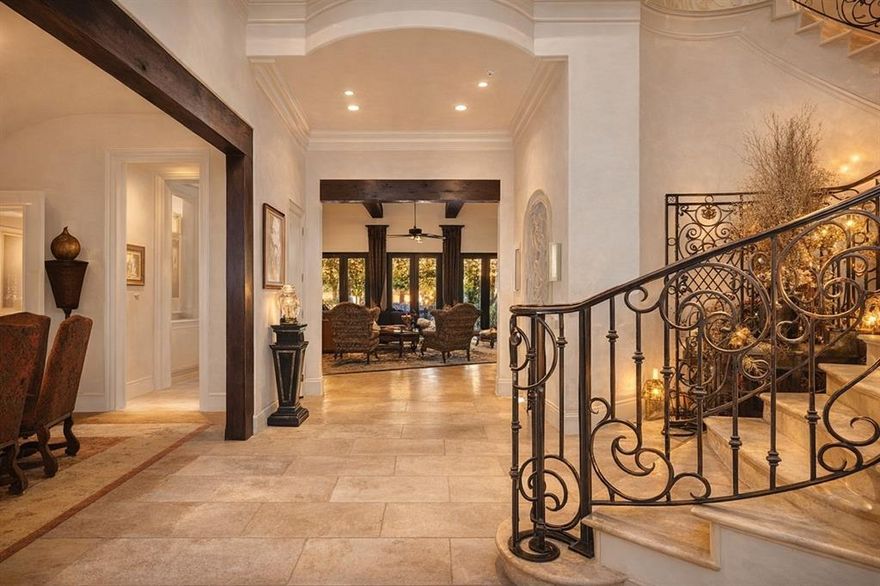 Step into this extraordinary home

A grand stone staircase with wrought iron railing welcomes you, set against floors of Turkish travertine. Exposed firewood beams painstakingly stained to perfection. The quality is so extraordinary that two cranes broke during installation.

Throughout the home, hand-scraped oak floors, multiple marble fireplaces crowned with elegant molding, and plantation shutters elevate every space.

The living room boasts gorgeous iron French doors that open to a sprawling outdoor patio, seamlessly blending indoor and outdoor living.

The oversized kitchen is a chef’s dream, featuring a massive granite island with oval seating for six, custom maple cabinetry, and top-of-the-line appliances.

For entertainment, enjoy a massive media room complete with billiards, home theatre, and a commercial-grade pub with stainless steel finishes.

The library-sized study is wrapped in rich maple wood paneling, with soaring ceilings, plantation shutters, and semi-circular windows that flood the room with natural light.

Stay fit in the exercise room, equipped with 4,500 lbs of professional-grade equipment.

Wine enthusiasts will love the climate controlled wine cellar, capable of holding 3,000 bottles.

The primary suite is a retreat in itself with a custom iron chandelier, breathtaking backyard views, and a spa like bathroom featuring diamond pattern granite floors, double sinks, an oversized shower with three body sprays, plus a urinal and bidet. The master closet boasts a soaring ceiling and a hidden passageway leading to the library.

Step outside to your resort-style patio, with an in-ground spa, towering 15-foot privacy fence, built-in grill, outdoor fireplace, oversized TV, double ceiling fans, and dining area — all watched over by two majestic custom stone lions.

This home is truly one-of-a-kind, offering a blend of artistry, function, and luxury that must be seen to be believed.
Photos enhanced with walls painted white