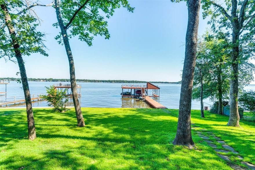 HUGE PRICE REDUCTION! This breathtaking Cedar Creek lake house offers an unparalleled lakeside lifestyle with a private dock featuring two boat lifts and three jet ski lifts, perfect for all your water activities. The expansive upper deck provides stunning sunrise and sunset views, allowing you to soak in the beauty of the open water. With water at the dock year-round, you'll have easy access to the lake no matter the season. Inside, the home has been thoughtfully updated, including a stunning kitchen renovation in 2023 and a brand-new refrigerator and dishwasher in 2024. Every room in the house boasts picturesque lake views, ensuring you’re always connected to the tranquil setting. The oversized yard and heavily treed lot provide ample space for outdoor activities and privacy, while the new seawall, completed in 2021, ensures long-lasting protection. This lakefront gem is the perfect blend of relaxation, convenience, and natural beauty. Misty Harbor 20' 2020 Tritoon with Mercury 150 motor and Sea Doo jet ski available for purchase separately along with some furniture.  Washer Dryer are included. All measurements to be verified by buyer or buyer’s agent.  Agent is homeowner.