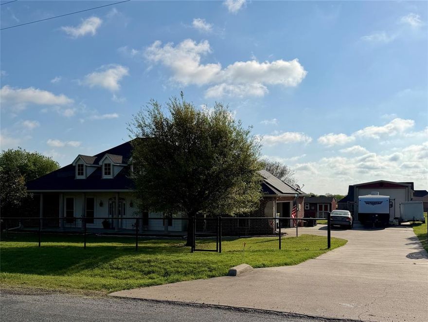 PRICE REDUCTION on this beautiful custom built 3bd, 2.5 bath sitting on an acre located in Red Oak ISD, NO CITY TAXES.  Nice size kitchen has beautiful wood cabinets with lots of storage, pantry with another lrg closet around the corner makes a great overflow pantry if needed.  It is open to the breakfast area and living room.  Bedroom are spacious.  Laundry room has wood cabinets too.  Acre is fully fenced with pipe fencing and electric gated entrance....lots of concrete space so kids can ride their bikes or skate.  Nice established trees.  The sprinkler system covers front, sides and back to the garden area.  Backyard is screaming for a pool.  Tornado room in the oversized garage. Solar panels stay with property, paid in full.  Workshop is 18x48 with electricity and concrete flooring and has a large storage room with loft on back end.  Bldg in backyard is being used as a garden shed, could be a cute She Shed.  This home is a must see to see and feel all the space.