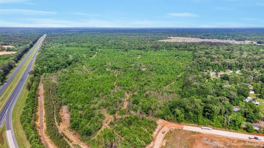 Experience the immense potential of this prime piece of real estate located right on the bustling interchange of I-20 and the Haughton Exit. With approximately 211 sprawling acres set against the vibrant backdrop of the I-20 On Ramp heading East, this location boasts convenience and accessibility.  Seamlessly connected, you can easily reach this property by taking the I-20 Haughton Exit 33. From Exit 33, stay in the right lane trajectory onto Hwy 157, make a smooth left turn on La-3227, and another left on Aqua Drive. The easy ingress and egress this location offers make it easily accessible.  Imagine a bustling Super Grocery Store, catering to the day-to-day needs of the locals.  This property would make a great Marketplace with travel center, hotel, restaurants, banks, etc. Also perfect for a distribution center.  So many opportunities on this large tract.  See it today!