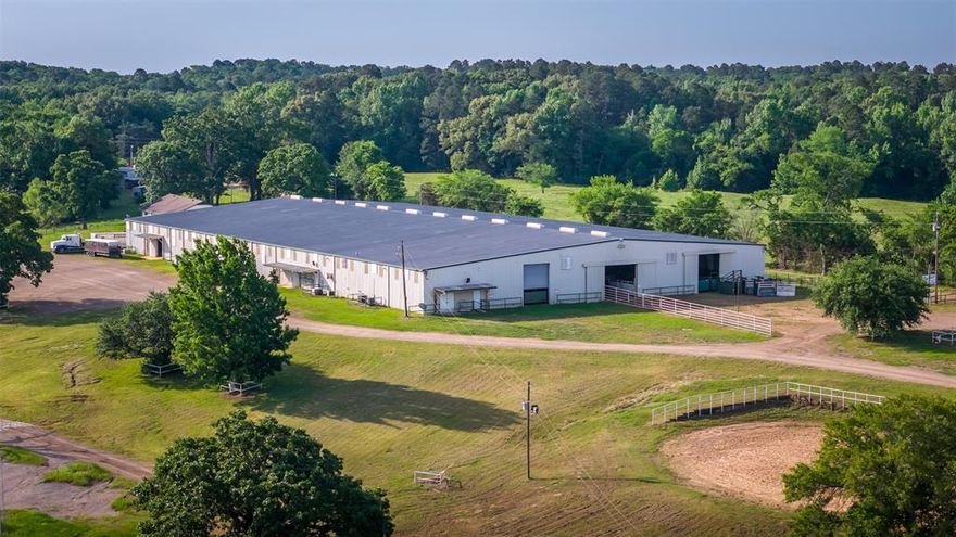 A truly rare opportunity to own a premier commercial equestrian arena and event center just 10 minutes from Interstate 30 and Mount Pleasant. Offered for the first time as a complete package with 117 acres, this one-of-a-kind facility is designed for competition, events, income production, and ranch living all in one exceptional property.
The centerpiece of the ranch is a state-of-the-art climate-controlled indoor arena, fully equipped with bucking chutes, Priefert roping chutes, spectator bleachers, public restrooms, offices, and a commercial-grade kitchen with concession stand—ready to host rodeos, jackpots, clinics, private events, and large gatherings.
Equine improvements include 50 horse-ready stalls, plus an additional barn with 13 pipe runs built to accommodate bucking bulls or specialized livestock operations.
The topography of the property showcases stunning views- the main residence, several large shops, and the second barn sit across a creek and atop a hill overlooking the property.  Pastures are fenced and cross-fenced, nicely cleared, and well maintained.
Residential improvements are equally impressive, featuring a stunning 5,194-square-foot Austin stone main residence with a pool overlooking the ranch, two separate 3-bedroom, 2-bath brick homes currently producing incomel, and a barn apartment for guests, staff, or additional rental use.
Whether you’re seeking an established event venue, income-producing investment, or legacy ranch property, this offering presents endless possibilities in an ideal East Texas location.  Mount Pleasant is home to a full-service hospital and ER with helipad, numerous hotels, and is less than  2 hours from the DFW metroplex, 40 minutes from Sulphur Springs, and 1.5 hours to Tyler.
