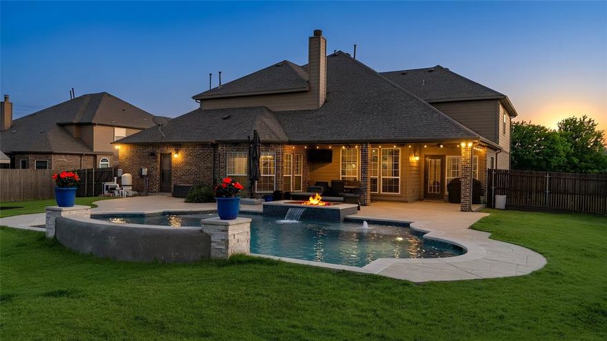 Positioned on a sprawling half-acre estate in Haslet, 1424 Fence Post Drive is a striking two-story residence that embodies elevated design, refined comfort, and an exceptional indoor-outdoor lifestyle. This thoughtfully designed layout includes 5 spacious bedrooms & 3.1 baths. This home offers both architectural presence & effortless livability. Upon entering, you will be immediately drawn to an amazing Game & Bar Room. This space is an entertainer's dream. OR...If preferred, you could easily use it as a large dining and seating area. YOUR CHOICE! The Chef's kitchen overlooks the dining area & a large open living space w corner stone fireplace &  pool views. The private, downstairs primary suite has a large bay window overlooking the pool. Also, downstairs is an office with built-in shelves. The stunning wrought iron stairwell invites you upstairs & offers an incredible extension of living space. The additional living area and dedicated Media Room provide a separate space to unwind & enjoy movies. The 4 large Upstairs Bedrooms provide comfort and privacy for family or guests. Beyond the doors, a resort outdoor retreat unfolds. The pool glistens beneath open skies, framed by an outdoor living area designed for sophisticated entertaining and relaxed evenings alike. Relax & enjoy conversations around the firepit & pool fountains.  As day transitions to night, sweeping sunset views create a breathtaking backdrop—delivering a sense of serenity 

Inside, the home is equally impressive. Expansive living spaces are filled with natural light, creating an airy, inviting atmosphere, while clean lines and a seamless flow elevate the overall aesthetic. A dedicated media room offers a true cinematic experience, perfect for private screenings or game-day gatherings.

Set on an oversized homesite with room to breathe, this residence offers a rare blend of privacy, scale, and luxury—crafted for those who appreciate both refined interiors and exceptional outdoor living.