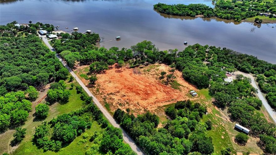 Ready to make a splash this summer? This 7.54-acre slice of paradise on Amon G. Carter Lake is calling your name! With plenty of elbow room and over 7 acres to roam, it’s the perfect canvas for your lakefront dreams—whether that's a cozy cabin, a party pad, or just a hammock under the stars. Spend your days reeling in bass, cruising the waves, or simply soaking up the sun with unbeatable views that’ll have your friends begging for invites. With water access, peaceful vibes, and space to play, this is lake life the way it should be—relaxed, fun, and full of possibilities. Summer’s better on the water... don’t miss your chance to own it!