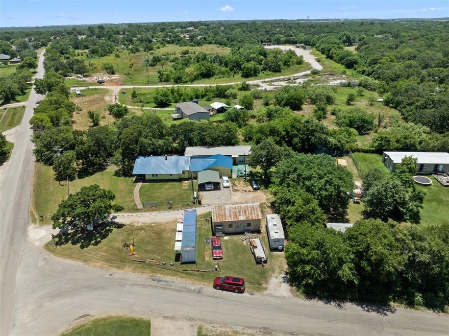 Hard corner out of the city limits! This is a prime spot for making the existing house and buildings into office space for a car lot or outdoor storage space business! 186' of road frontage on County Road 527 and 203' of road frontage on Renfro for a total of .898 acres! Bring your checkbook and imagination to this one!