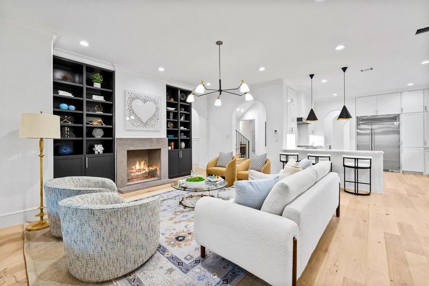 This Preston Hollow modern Tudor has been fully redesigned & reimagined. The front elevation is covered with windows, pouring natural light into the home all hours of the day. Upon entry, you're greeted by an arched opening to the formal dining room. Through another oversized arched opening, the backdrop to your formal dining is an art wall that also connects to a wet bar & butlers area. The chef's kitchen is complete with an agreeable & neutral palette with quartz counters & a herringbone laid backsplash. The kitchen is open-concept to the downstairs living area. Also found downstairs is a private study with private access to the front porch. The primary bedroom downstairs provides private access to the backyard. The terrazzo-wrapped ensuite primary bathroom features floating dual vanities & a soaking tub. Upstairs features 4 secondary bedrooms, an over-sized game room, & a media room. Other highlights include a porte-cochère, 3-car attached garage, mudroom & utility room off garage.