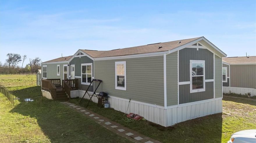 Mobile home does NOT include the land. Land lease is approx. $500 a month and includes lot lease, sewer and water depending on usage. Discover this 4-bedroom, 3-bath mobile home, built in 2021, situated on a premium in a small, quiet community! This farm style manufactured home showcases a modern kitchen with a large island that opens to a bright and spacious living room. You'll appreciate the space.  Step inside to find an open concept layout with tons of storage, a split bedroom design for maximum privacy and primary bedroom features ensuite bathroom. The kitchen offers ample counter space perfect for meal prep.  Close to lake.