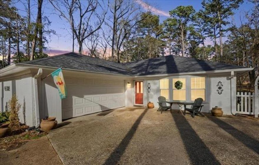 Welcome to this charming cottage-style residence nestled on a beautifully wooded lot in the sought-after community of Hideaway, Texas. This exceptional home offers an inviting open floor plan that seamlessly blends style, comfort, and functionality throughout its thoughtfully designed 1,800 square feet of living space. Upon entering, you will immediately appreciate the abundance of natural light that fills the expansive living area, courtesy of a stunning wall of windows spanning the entire rear of the home. These picturesque windows frame breathtaking views of the lush, tree-lined backyard, creating a serene backdrop for everyday living. The covered back porch provides an ideal setting for outdoor entertaining and relaxation throughout every season. The well-appointed kitchen serves as the heart of this home, featuring generous proportions and refined finishes that will delight both casual cooks and culinary enthusiasts alike. The spacious living area offers ample room for comfortable gatherings with family and friends. The thoughtful split floor plan positions the primary suite away from the secondary bedrooms, ensuring optimal privacy for homeowners. The large primary bathroom presents a tranquil retreat designed for unwinding after a long day. One of the most distinguished attributes of this property is the exceptional privacy afforded by the mature trees and generous lot, creating a peaceful sanctuary that feels worlds away from the everyday. This is a home you will truly never want to leave. Schedule your private showing today.