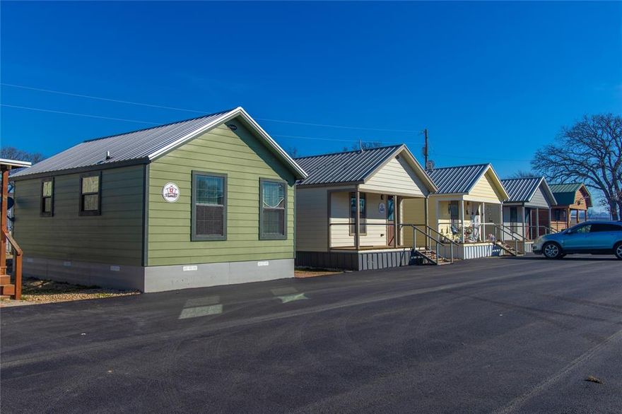 380 Eagle’s Nest is a turnkey investment opportunity located just off Hwy 380 in the Decatur ETJ of Wise County. This income-producing property features a tiny home community and storage facility on approximately 3.74 acres, generating $367,920 in gross annual revenue and $282,519 in net income, delivering a 10.5% cap rate. The property includes 16 custom-built tiny homes, each approximately 392 square feet, with full kitchens including a refrigerator, cooktop, oven, and microwave. Homes are not furnished. Water, electric, and trash service are included for tiny homes. A coin-operated laundry facility with Speed Queen commercial equipment is also on-site, adding convenience and additional income. The property offers 50 storage units and 5 parking spaces, with rental rates ranging from $50 to $1000 month. Operated on city water and septic, and located in the county, the site requires no city approvals for improvements or expansion. With low annual expenses of $85,401 and strong demand driven by the Decatur and DFW markets, this is a rare opportunity for stable returns and long-term growth. Aerial imagery is for illustration only. Property boundaries and acreage (approx. 3.74 acres) subject to survey. Sales price is not contingent on exact land size. Property to be sold by metes and bounds description. This property may be purchased individually or together with the adjoining asset as a single turnkey investment. For details on the companion listings, see: Storage Facility – MLS #21073775 and Tiny Home Community – MLS #21073865. Buyers have the flexibility to acquire either asset separately or both as one combined portfolio.