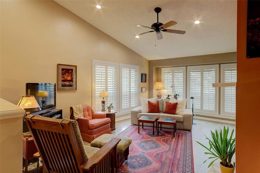 Welcome to your own treehouse retreat! Nestled among a canopy of mature trees, this end-unit condo on the second floor offers a sense of privacy and serenity that is hard to find. With lush greenery and a peaceful setting surrounding the unit, you'll feel removed from the fast city pace — yet right in the heart of one of North Dallas' most sought-after locations. The community includes and features a beautiful waterfall pool and tennis court and is ideal for the lock-and-leave lifestyle. Worth mentioning that the HOA has strong reserves, is very responsive and meticulously maintains community grounds. Step inside this unit to find vaulted ceilings in the dining and living rooms, floor-to-ceiling windows, and an abundance of natural light throughout the unit. Plantation shutters add a clean, finished look to every window. The living room features a cozy fireplace and opens to a floorplan that flows naturally, including two private balconies among the treetops. The kitchen offers granite countertops, black appliances, and updated white cabinets. The primary bedroom is generously sized with a full bath featuring a stand-up shower, garden tub, dual vanities, and ample closet space. The secondary bedroom is large enough for a roommate, family member, or home office, with a full bath just steps away. Sellers have invested approximately $30,000 in upgrades since 2021, including all-new aluminum Low-E windows (2022), luxury vinyl plank flooring (2021), a new AC unit (2023), and a new hot water heater (2021). The refrigerator, washer and dryer convey, making this truly move-in ready. A private garage with additional storage space and a covered parking spot completes the package. Bonus attic space above the garage provides convenient extra storage area for personal belongings. Adjacent to the prestigious Bent Tree Country Club, minutes from popular Addison, and with quick access to the DNT and GB Tollway, DFW and Love Field are just 15–20 minutes away.