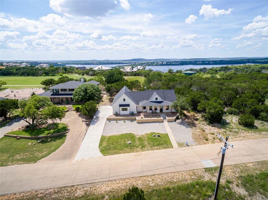 Live elevated at this new built 3-bedroom, 2-bathroom retreat designed to capture the beauty of the Palo Pinto Valley in The Cliffs Resort, one of the most coveted gated communities on Possum Kingdom Lake. This location is one of The Cliff’s best kept secrets that not only blows you away with the impressive views but also sits directly on the golf course. From the moment you arrive, you're greeted with modern farmhouse curb appeal and a covered front patio perfect for morning coffee. Inside, vaulted ceilings with exposed beams and polished concrete floors set the stage for effortless sophistication. The kitchen dazzles with granite countertops, a kitchen island, walk-in pantry, floating shelves, and striking black and gold finishes. The split-bedroom layout ensures privacy for guests, while the expansive primary suite offers a spa-inspired bathroom and massive walk-in closet with direct access to full laundry room. Full use 2 car garage with smart remote opener, natural light window, and side entry. Outside, the covered back patio opens to golf course views, an ideal setting for quiet evenings or possible future poolside entertaining. Enjoy world-class amenities which includes 36 rounds of golf a year, a full service marina, onsite security, community swimming pool, clubhouse, restaurant, fitness center, and tennis courts. This is more than a home, it’s a luxury lifestyle on the lake.