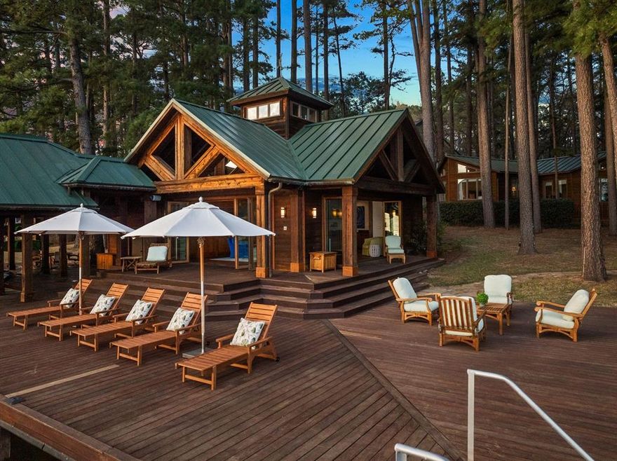 Expansive lakeside retreat combined with luxury living and unmatched amenities awaits you on the serene shores of Lake Cypress Springs. Discover the ultimate in lakeside luxury with this expansive 4,828-square-foot retreat, perfectly situated in the sought-after Eagle Point Community. Set along 211’ of shoreline, this residence provides sweeping panoramic views and a tranquil backdrop of towering pine trees. Custom design, with entertaining in mind, the open floor plan features a chef’s kitchen, two spacious dining areas, a cozy living room with a fireplace, conservational seating, and a pool table, making it a perfect place to host gatherings of all sizes. Each bedroom boasts its own elegantly appointed ensuite. Retreat to the master suite, your personal oasis featuring luxurious finishes and sitting area. Even more, a kids’ wing that is specially outfitted with a boy’s bunk bed and a girl’s whimsical bedroom. The dedicated kids’ hangout area offers a cozy movie nook, ensuring fun and comfort for younger guests. Step outside to an expansive outdoor retreat with a Green Egg grill area, perfect for al fresco dining and summer barbecues. The best part? A grandfathered-in Lake Lodge that is 884 sq ft fully enclosed, climate-controlled, and an entertainer’s haven, complete with a bar, lounge seating, and panoramic views. The boathouse is outfitted with automatic boat and jet ski slips for effortless lake access. This exceptional property is offered fully furnished, including the boat and jet ski, so you can start enjoying the lakeside lifestyle from day one. This home offers additional amenities such as a cozy fire pit, a horseshoe or bocci pit, and additional boat dock spaces for your guests to anchor. These features make for convenience, entertainment, and unparalleled comfort, making it the perfect retreat for those seeking both relaxation and adventure. Schedule your private tour today and experience lakeside luxury living for yourself.