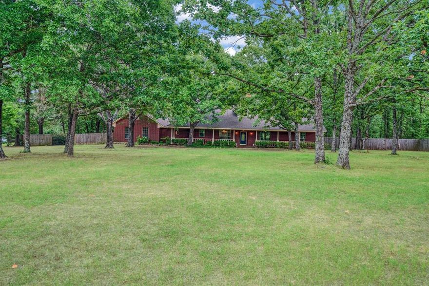 BEAUTIFUL HOME TUCKED AWAY ON 2.41 ACRES. SITS OFF THE STREET FOR PRIVACY. BEAUTIFUL FRONT PORCH SPANS 52 FEET FOR OUTDOOR ENJOYMENT.  TREE SHADED LOT.  ENTRY OPENS UP INTO LIVING DINING WITH BEAUTIFUL STAIRWAY, FIREPLACE AND HIGH CEILINGS.  KITCHEN WITH LARGE WINDOW.  BREAKFAST ROOM OVERLOOKS BACK YARD.  SUNROOM WITH PLENTY OF WINDOWS WITH BEAUTIFUL VIEWS.  OFFICE HAS CLOSET.  3 BEDROOMS AND 3 BATHS ON FIRST FLOOR.  2 BEDROOMS AND 1 BATH ON SECOND FLOOR.  LARGE BALCONY AREA CAN BE USED AS DESIRED. LARGE UTILITY ROOM (GAS AND ELECTRIC HOOKUPS) WITH SINK AND BUILT IN IRONING BOARD.  THE KITCHEN RANGE IS DUAL FUEL, THE TOP IS GAS AND THE OVEN IS ELECTRIC.  REAR ENTRY GARAGE.  31 X 31  WORKSHOP HAS SHOWER, SINK AND TOILET, 2 ROLL UP DOORS AND 1 PERSONEL DOOR. PROPANE FOR GAS JETS.