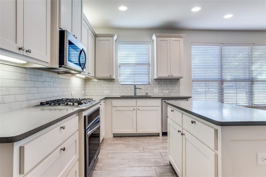 Welcome to this beautifully maintained and updated corner lot townhome featuring a light filled layout designed for modern living. Large windows throughout the home invite in an abundance of natural light, while the adjacent green space offers a sense of privacy and an open view rarely found in townhome living. The main level showcases an inviting open floorplan highlighted by decorative lighting and an eat-in kitchen perfect for everyday life and entertaining alike. The kitchen features quartz countertops, tile backsplash, an island, stainless steel appliances, gas cooktop, and microwave replaced in 2022. A convenient powder bathroom on the first floor adds comfort for guests, while smart home upgrades including an Ecobee thermostat, Ring doorbell, Ring cameras and a rear floodlight provide peace of mind. Upstairs, the spacious primary bedroom offers a large walk-in closet and an en-suite bathroom complete with separate vanities and a new toilet installed in 2022. Secondary bedrooms both feature generous closet storage, and the secondary bathroom has marble countertops and an upgraded shower head. A versatile loft area provides flexible space ideal for a home office, workout zone, or play area. Additional highlights include a tankless water heater for efficiency and comfort, plus the ease of low-maintenance living with HOA provided yard care. Residents also enjoy access to neighborhood amenities including a clubhouse and community pool. Ideally located near Craig Ranch with quick access to Hwy 121, this home is minutes from shopping, dining, and entertainment, including Allen Premium Outlets. Zoned to highly sought after Frisco ISD with top ranking schools, this townhome blends comfort, convenience, and location into one exceptional opportunity.