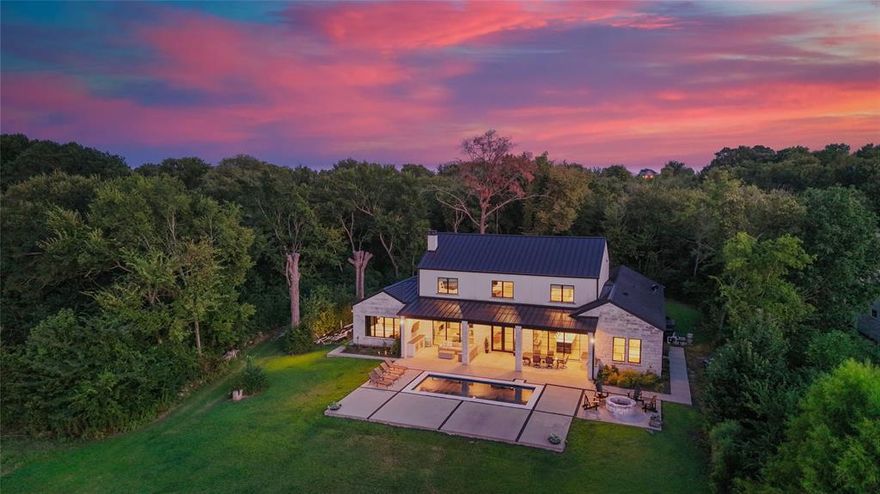 Nestled on 3.46 acres with 131 feet of open water front, this extraordinary estate is one of only 6 estate size homesites in the exclusive gated 505 Ranch just 45 minutes from Downtown Dallas. This premier community with 56 waterfront home sites lends lakefront luxury with ranch-style living across 505 pristine acres on the shores of Cedar Creek Lake. A long, wooded driveway leads to a striking modern lake home featuring open-concept great room flooded with natural light through tall windows that frame panoramic water views. A stone fireplace, built-ins, wood floors, and wood-beamed ceilings add warmth and character, while the state-of-the-art kitchen is a chef’s dream, featuring high-end appliances, a gas range, double ovens, and an expansive island with wine fridge and ice maker. The main level hosts two lake-view primary suites with baths along with a spacious utility room and a built-in workspace. Upstairs, the bonus room invites relaxation and entertainment with a large sectional, pool table, and wet bar equipped with a sink, fridge, and microwave. Two custom-designed bunk rooms, both with ensuite baths and water views, provide ample space for guests. Step outside to a large covered patio featuring a mounted TV, ceiling heaters, and a Coyote grill. Stunning pool with both heater and chiller, a stone firepit, and a lush lawn leads to private boathouse with composite decking, covered seating, two jet ski lifts, a boat lift and party deck. As part of 505 Ranch, residents enjoy exclusive access to over 400 acres of unmatched amenities including an equestrian center, guest cottages, polo field, pickleball courts, skeet range, hiking and ATV trails, stocked fishing ponds, a clubhouse, pool, sandy beach, and full-time ranch staff with concierge services. Whether you’re seeking a serene retreat or an active lifestyle, this rare offering delivers the best of both worlds.